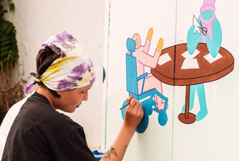 Artist painting utility box